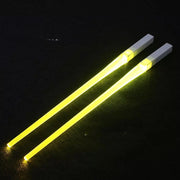 A reusable party utensil with nine colored fluorescent sticks and glowing chopsticks